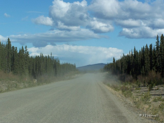 100_1312_YT_AlaskaHwy_Dust.jpg - When you see dust ahead you know that it is either construction or a gravel road. In this case it was a gravel road... the first section of gravel road that we came to.  ~May 21, 2004, Mile Marker 745, Alaska Highway - Yukon Territory