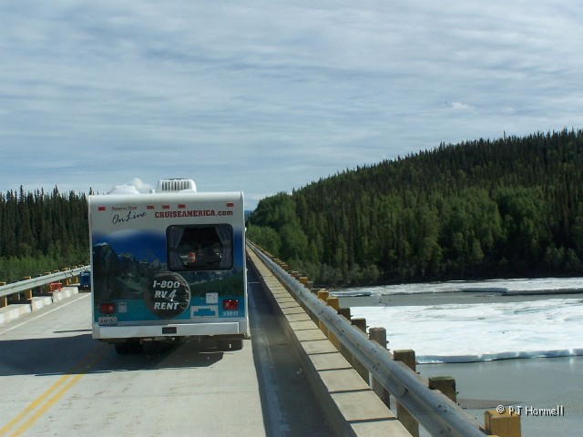100_1706_AK_AlaskaHwy_Ice.jpg - Robertson River - Thick ice and snow still covered many streams. This looked about a foot thick.  ~June 3, 2004, Mile Marker 1347 - Alaska Highway - Alaska