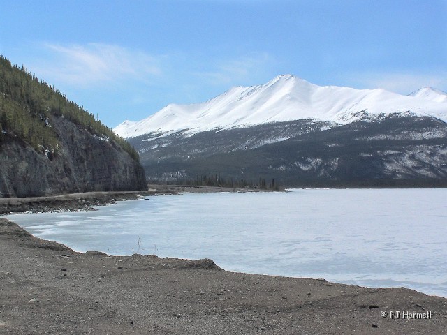 100_8170B_BC_AlaskaHwy_MunchoLake.jpg - A frozen scene where the Alaska Highway runs along Muncho Lake.  Milepost 436, British Columbia, Canada  ~May 16, 2006