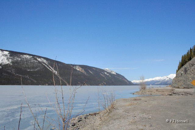 IMG_0994_BC_AlaskaHwy_MunchoLake.jpg - Muncho Lake was still frozen and just beginning to thaw along the shoreline. Milepost 435 Alaska Highway.  British Columbia, Canada ~May 15, 2006